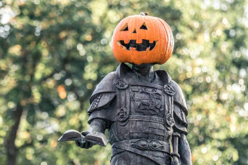 King Alfred statue with a pumpkin on his head