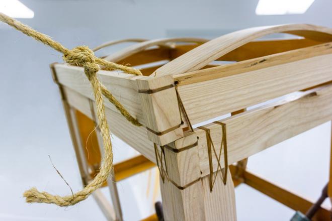 Wooden crate, suspended by rope, detail.