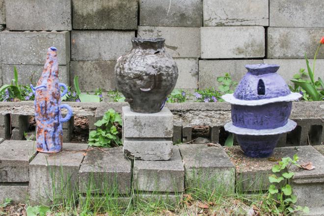 Three ceramic vase forms, pictured outside.