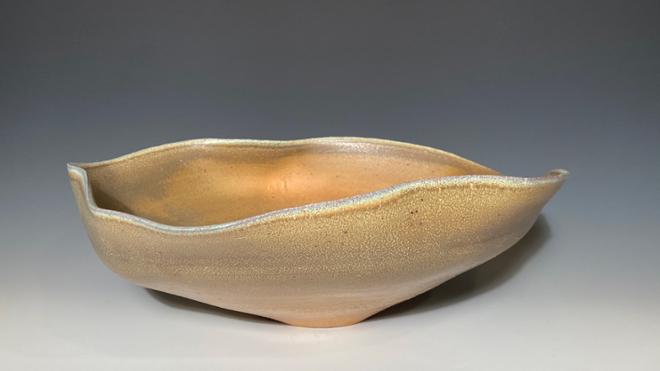 An orange oblong ceramic bowl. 