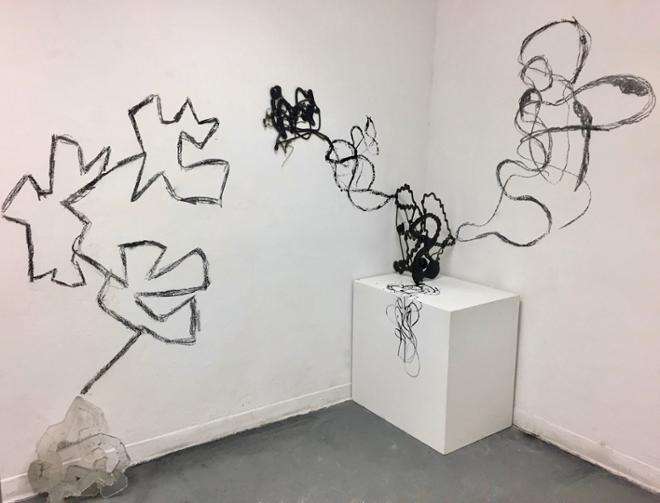 Abstract form on pedestal, drawings extended onto walls.