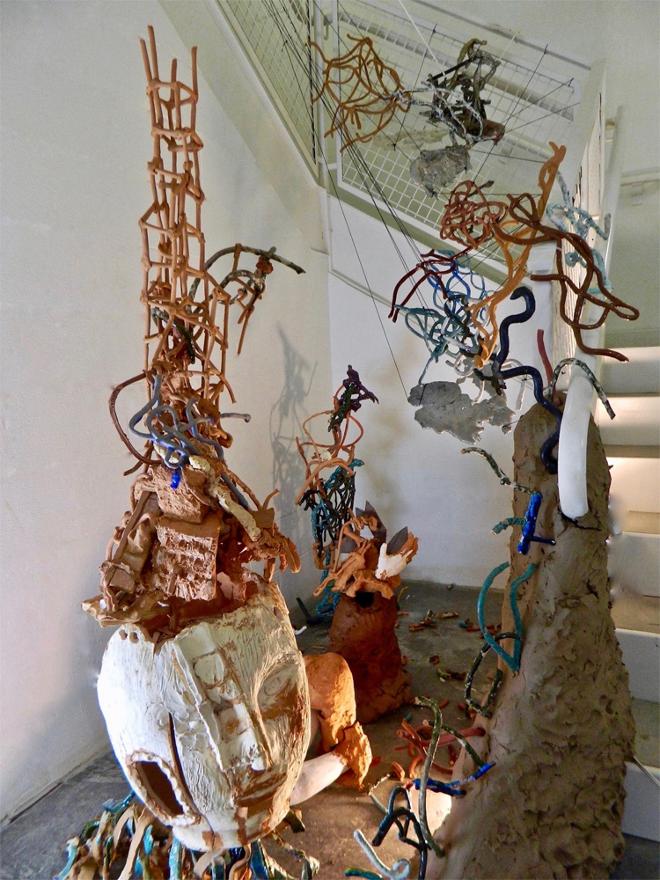Abstract sculptures displayed in stairwell.