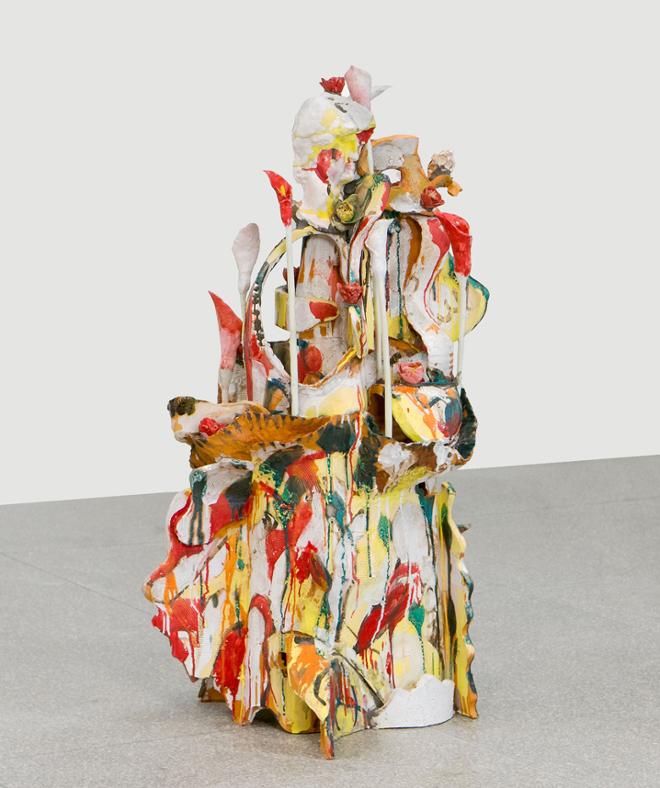 Abstract sculpture consisting of gestural shapes with red, yellow, and green splatter. 