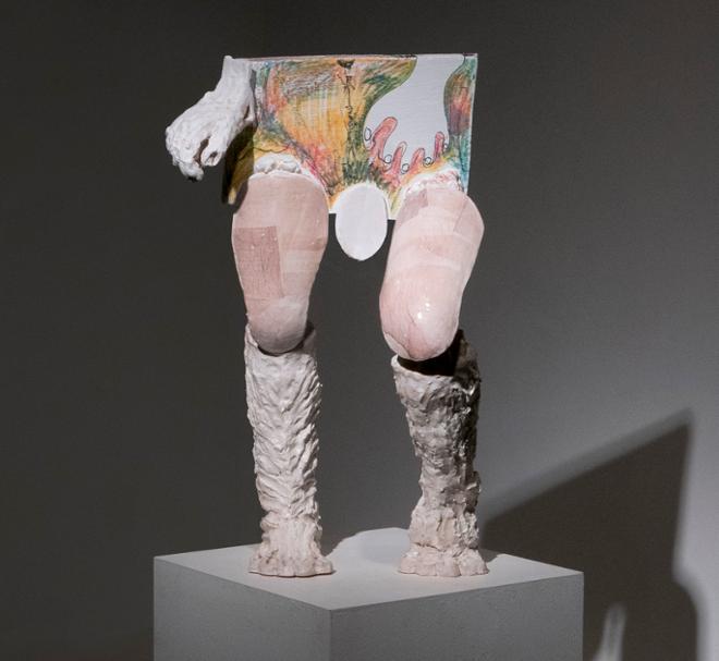 A mixed media sculpture that resembles the lower body of a person as well as hands. 