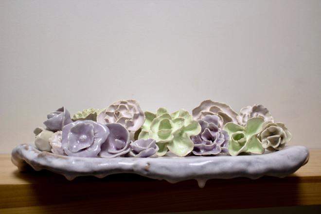 Ceramic flowers on a platter.