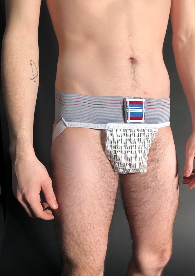 A photograph of a person wearing a knitted jock-strap. 