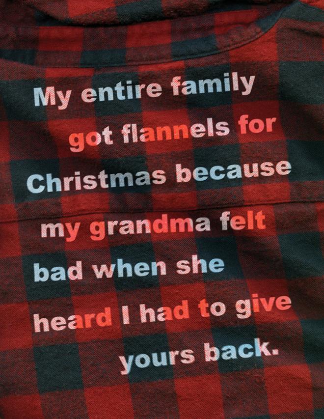 A block of text printed onto a plaid flannel shirt. 