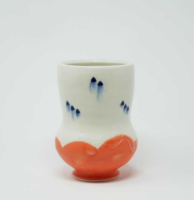 A white ceramic cup with salmon bottom 