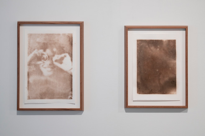 display of two framed sepia colored screen prints by Lucy Kim