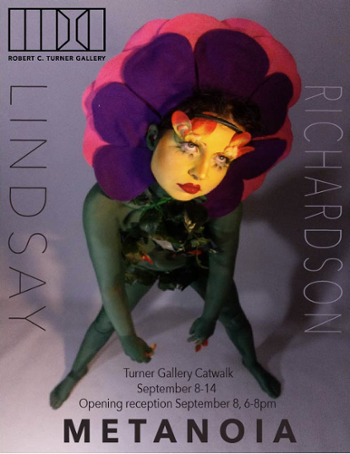 purple poster with figure in green with flower hat surrounding yellow painted face